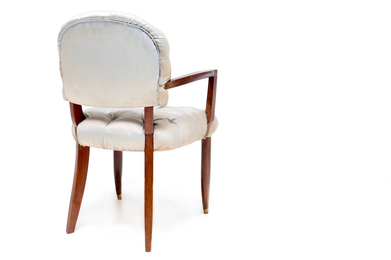 Art Deco Armchair by Jules Leleu in mahogany with gilt bronze sabots
with the original silk buttoned upholstery.