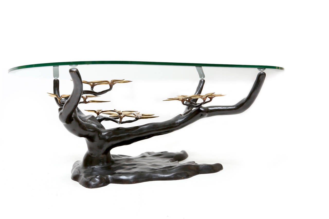 A Willy Daro brass coffee table with glass top.
Beautiful and organic tree form with gold leafed leaves.
Base measures 33.5