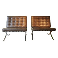 A pair of Barcelona chairs designed by Mies van der Rohe.