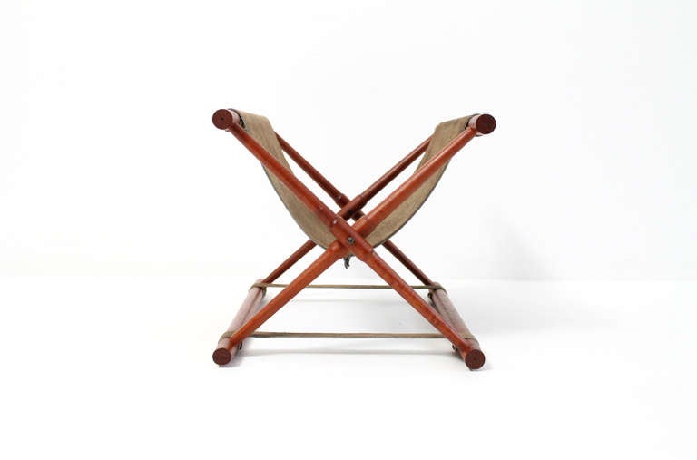 Danish magazine rack or stand in teak with suede sling.  Teak frame can fold flat when not in use.  Dimensions when closed: W: 19.25