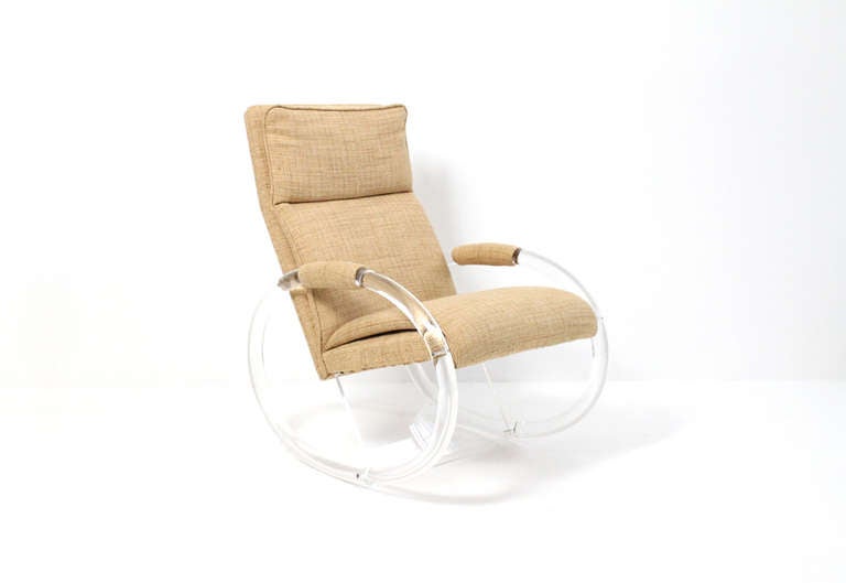 Rocking chair designed by Charles Hollis Jones in lucite and upholstery.  The upholstered frame is supported by two tubular pieces of lucite and a supporting rectangular piece.  Chic and comfortable seating.