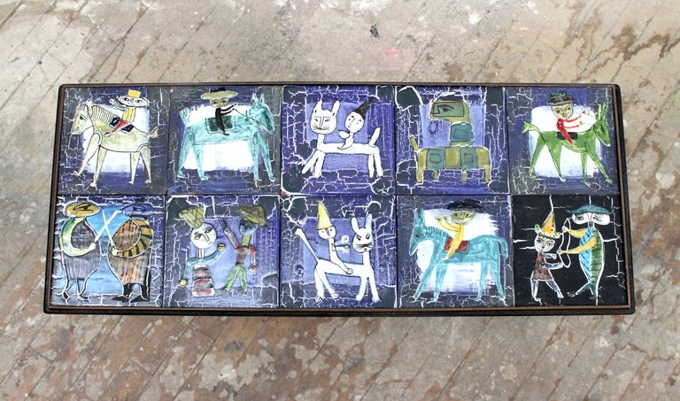 10 ceramic tiles by listed artist Bruno Capacci inset into a brass and iron frame.