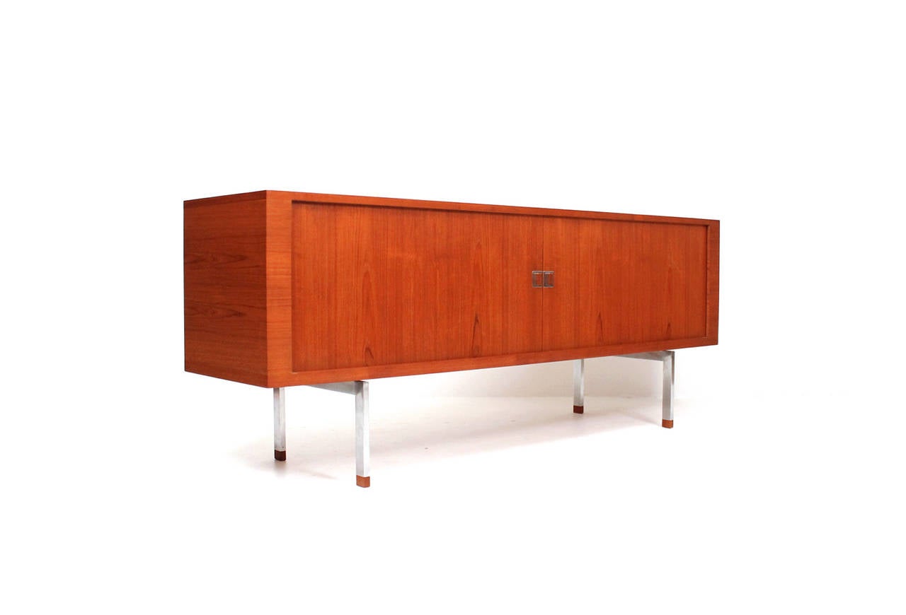 Teak and steel "President" sideboard by Hans Wegner for Ry Mobler. Tambour doors conceal an oak interior with drawers and adjustable shelves.