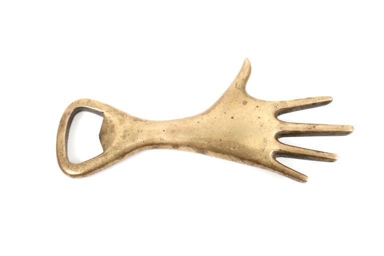 Hand shaped bottle opener made in the workshop of Austrian designer Carl Auböck. Solid brass is beautifully and deeply patinated.