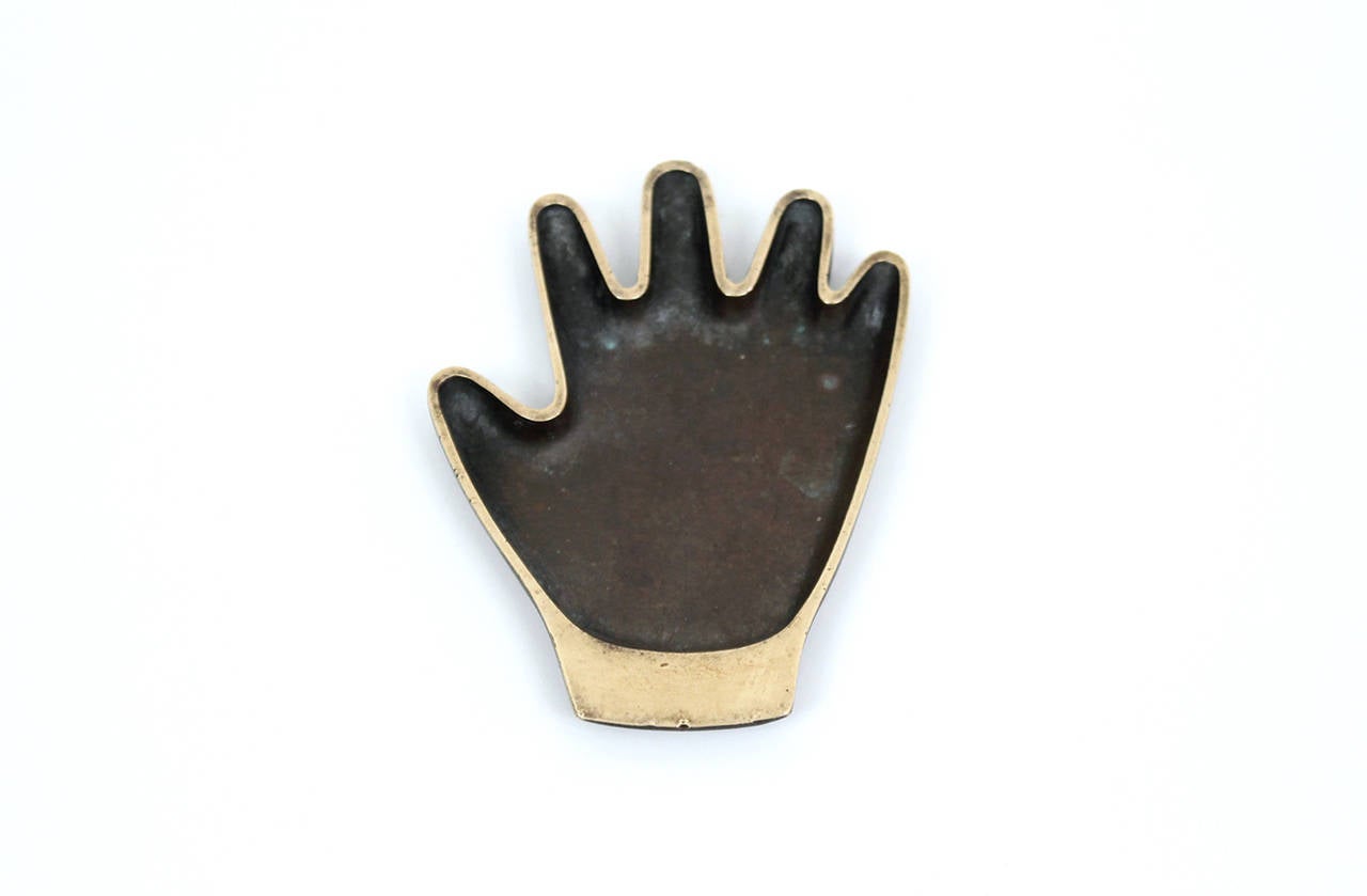 Graphic and playful hand shaped brass tray by Hagenauer Werkstätte. Piece retains original patina. Perfect for a watch or wallet or as a desk accessory. Marked to underside with the 