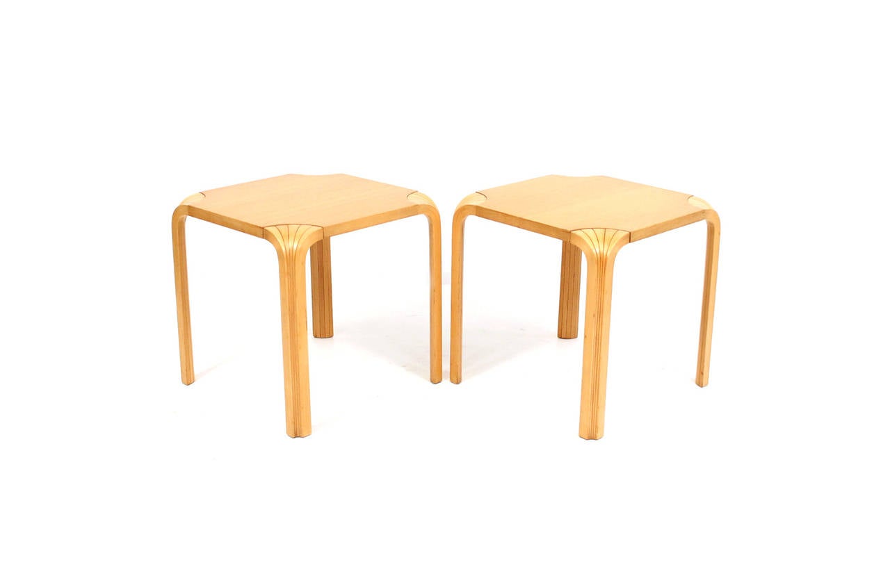 Period pair of side tables designed by Alvar Aalto for Artek with the fan leg detail.  Warm patina to original finish.  Size of tables is very accommodating for use in a variety of interior settings.  Signed with Artek and ICF import marks.