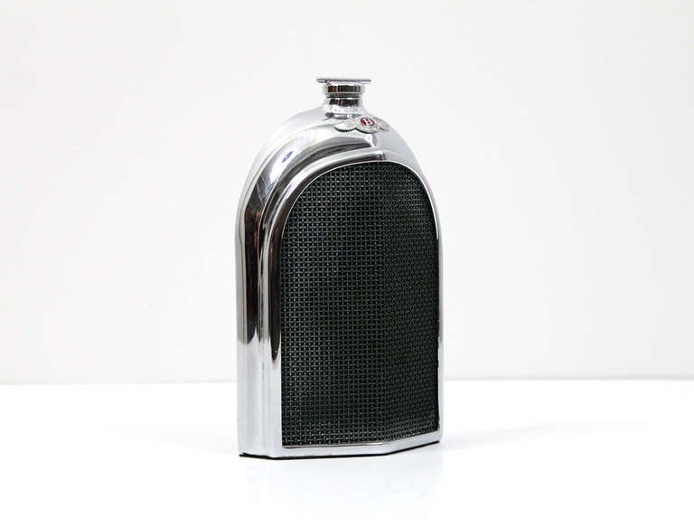 Rare Bentley radiator decanter by British maker Ruddspeed.  Dates to the 1960s. Made of chromed stainless steel complete with scaled replica Bentley winged badge and dog-bone radiator cap.  Mesh grille.  Stamped 
