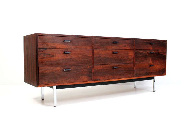 Long nine drawer dresser by Harvey Probber in rosewood with chrome legs and black enameled metal handles.  Expressively grained rosewood veneer throughout including a stunningly figured bookmatched top.
