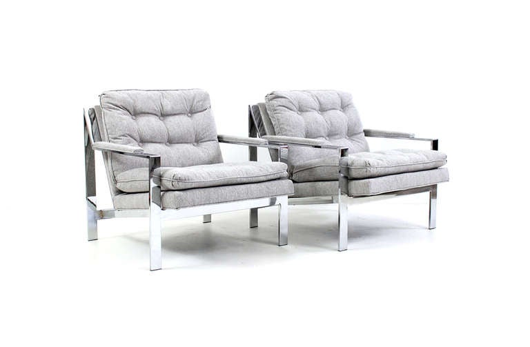 Desirable pair of large flat bar chrome lounge chairs by Cy Mann for Cy Mann Designs LTD. This design is often attributed to Milo Baughman.  Recently reupholstered.  Comfortable and attractive pair of chairs.