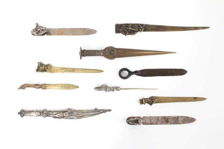 This collection of ten early 20th Century letter openers includes a bronze dagger form,  another bronze example with a bulls head marked 