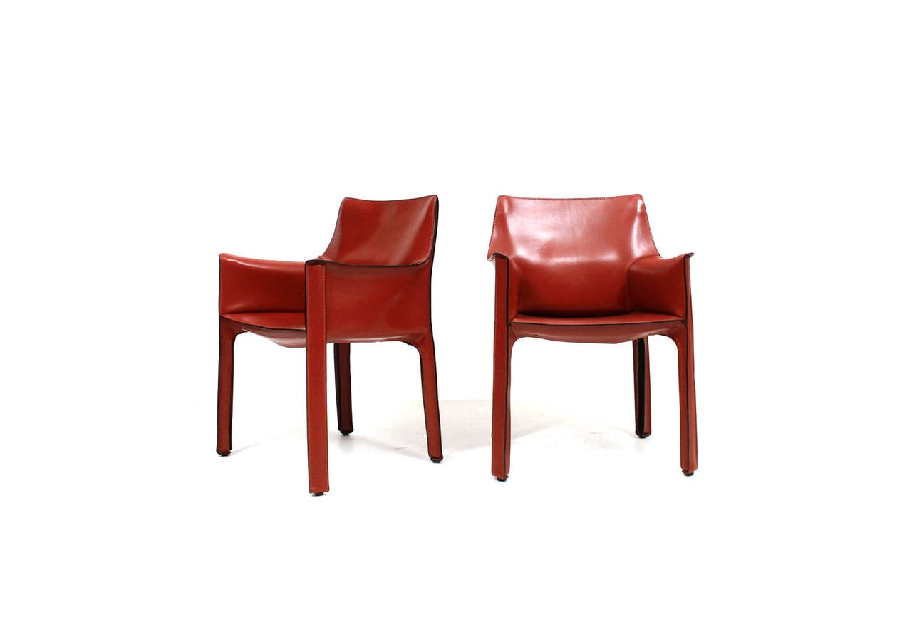 Set of six CAB armchairs by Italian designer Mario Bellini for Cassina. This vintage set is in near perfect condition and in a desirable red orange leather. Branded and labeled to underside.
