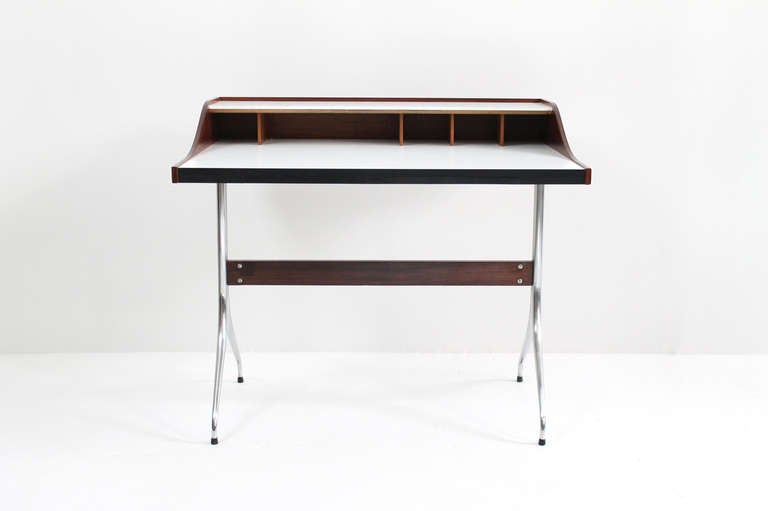 George Nelson Swag Leg desk model #5850 in rosewood, white laminate, and chrome plated steel.  Designed in 1954, this particular example includes a rare all rosewood cubby format rather than the oft seen multi-colored ones.  A fine vintage example