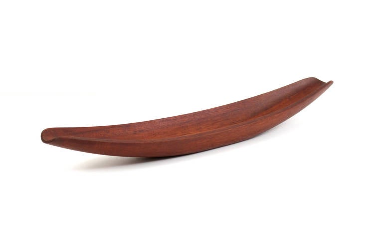 Staved teak fruit bowl designed by Jens Quistgaard for Dansk.  This is an early version of the canoe bowl stamped with the 