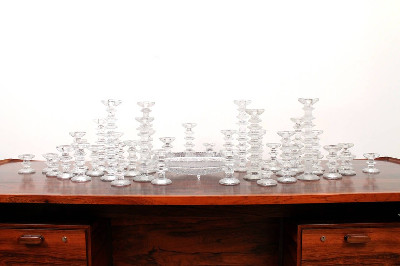 Large collection of 41 Festivo glass candlesticks by Timo Sarpaneva and centerpiece bowl by Tapio Wirkkala both for Iittala.  Some signed with etched TS and others with applied Iittala stickers.