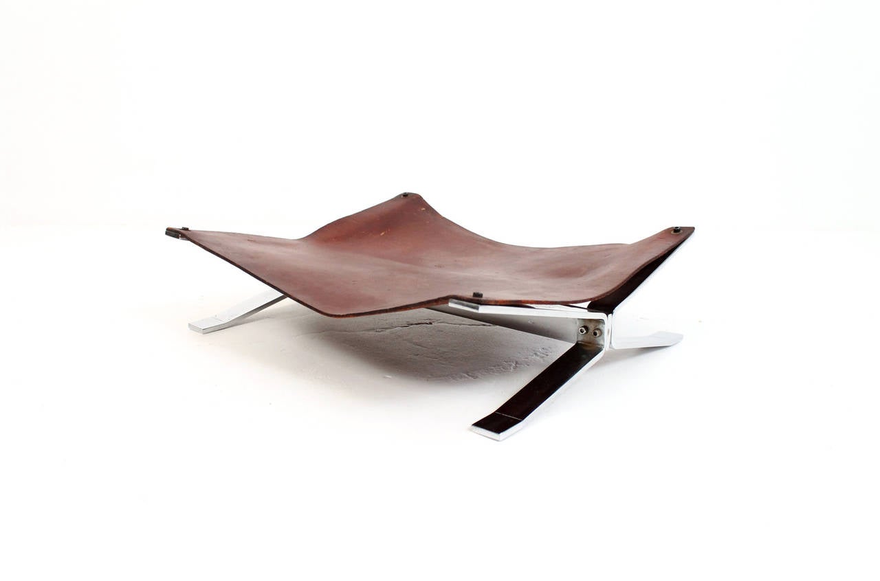 Very attractive log or magazine holder catch all by Alessandro Albrizzi. Its striking angular chrome base supports a superb brown saddle leather sling. Useful in many different interior settings. All original.