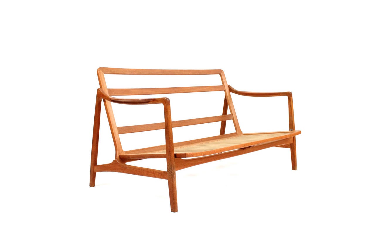 Early loveseat or sofa by Tove & Edvard Kindt-Larsen for France & Daverkosen.  This seldom seen design in oak with teak arm pads retains its original upholstery. Useful size and sculptural Danish form.