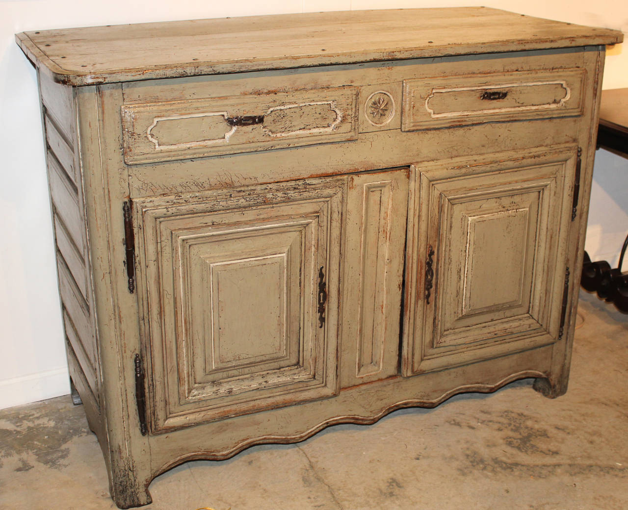 18th century French Provincial polychrome server or buffet, with two drawers and doors, which open to reveal one interior shelf. Nicely paneled with scrolled apron and appears to retain original hardware. Restored gray paint with white highlights.