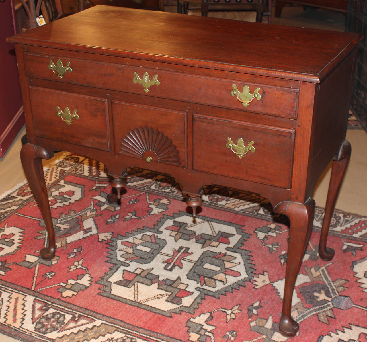 A nice example of an 18th century Connecticut cherry wood highboy base or server now fitted with a top. The base with one long drawer over three short drawers, the central with carved radiating fan decoration all raised by four cabriole legs,