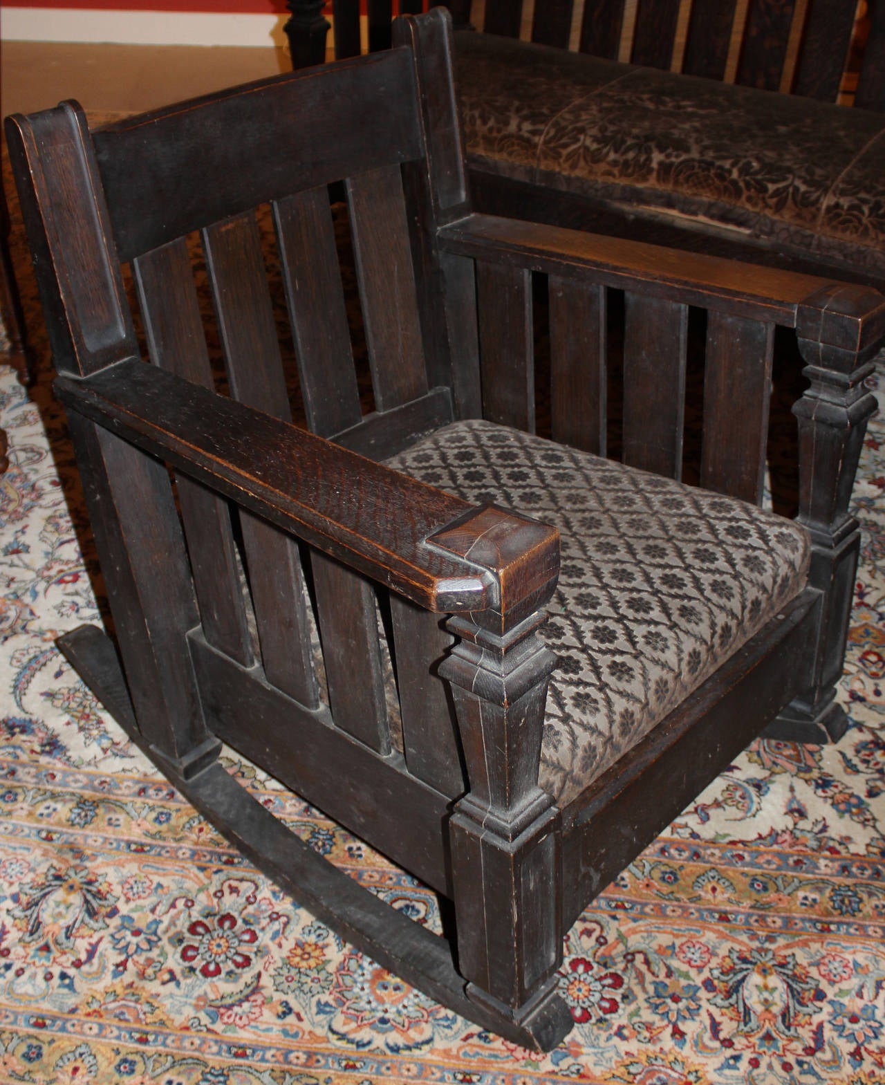 A solid Arts & Crafts oak rocking chair and matching settee with great patina, circa 1910-1920, with what appears to be original upholstery.