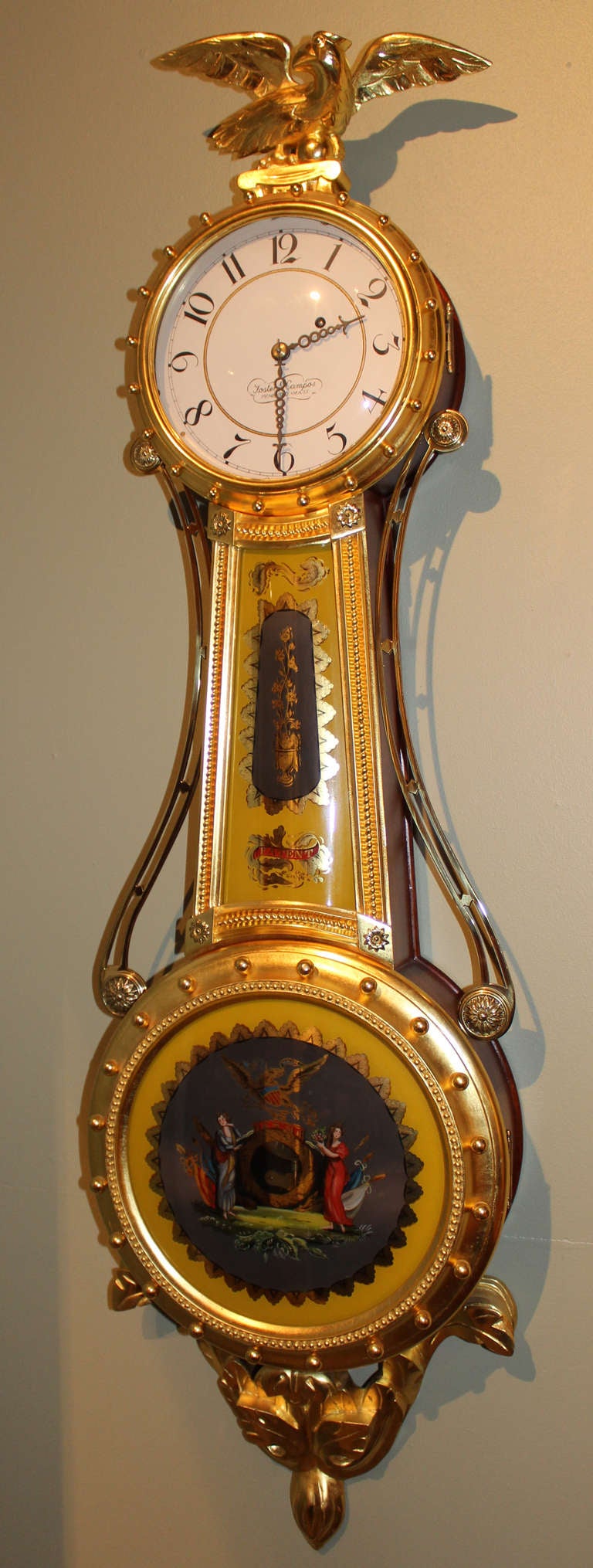 This is a wonderful 20th century mahogany Girandole wall clock by Foster Campos, Pembroke, Massachusetts with gilt eagle finial, bezel, lower pediment and frames enclosing the reverse glass eglomise painting on convex glass by Linda Abrams, Waltham,