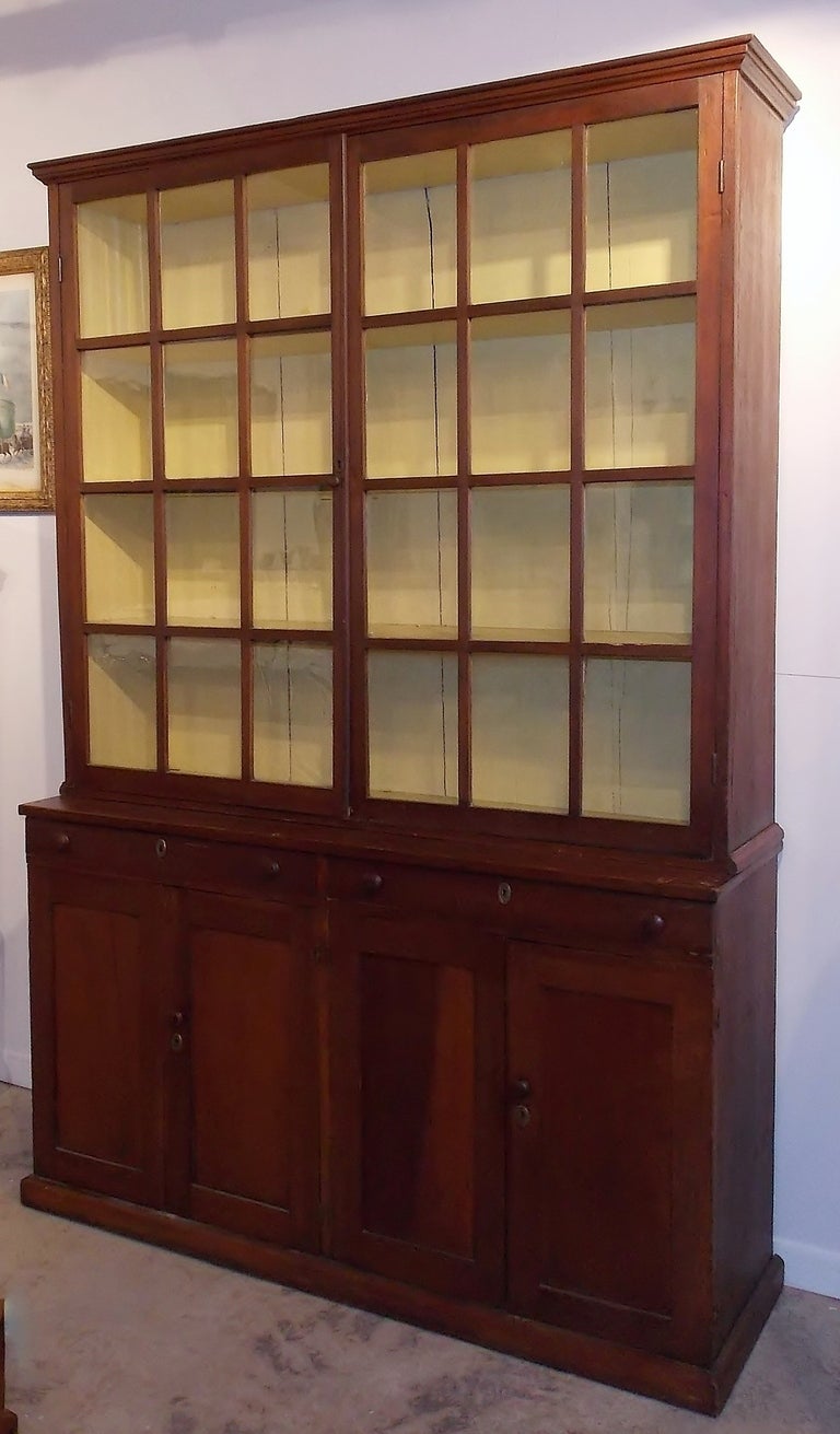 Early 19th century cherry stepback cupboard in 2 parts.  Glazed doors retaining most of original glass.  Circa 1810-1820.