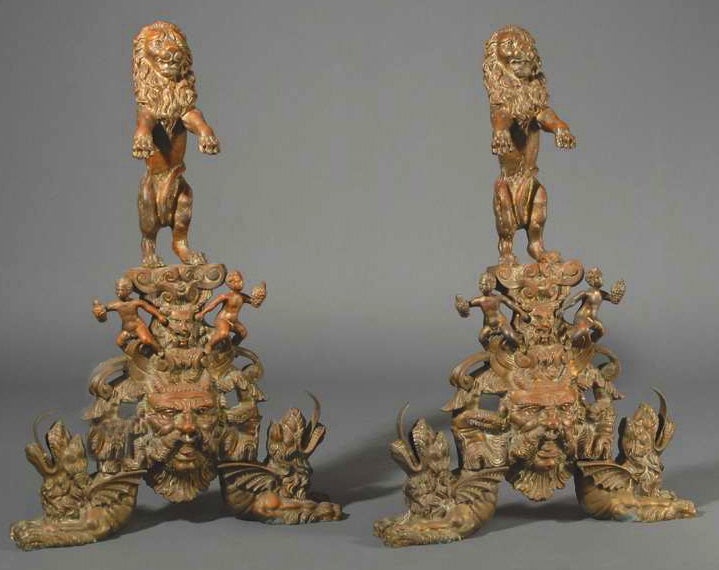 A large pair of andirons with lions and gargoyles.