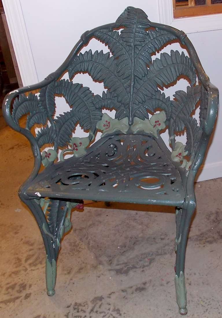 Great cast iron garden chair with fern motif, circa 1880-1890. Repainted with some paint imperfections, but ready for a new sharp coat of black, green or sandblast if so desired.