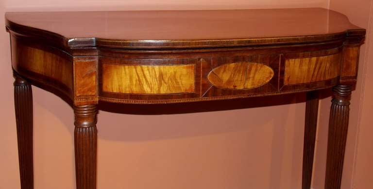 Federal serpentine card or gaming table attributed to John & Thomas Seymour circa 1800-1810.  Mahogany with inset panels and beautifully reeded legs.  Width of table with top open is 36.5