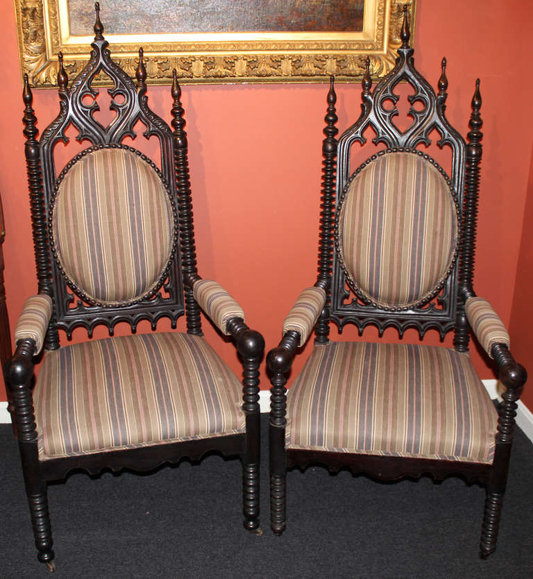 A wonderful near pair of 19th c. gothic chairs with dramatic carving and nicely upholstered.