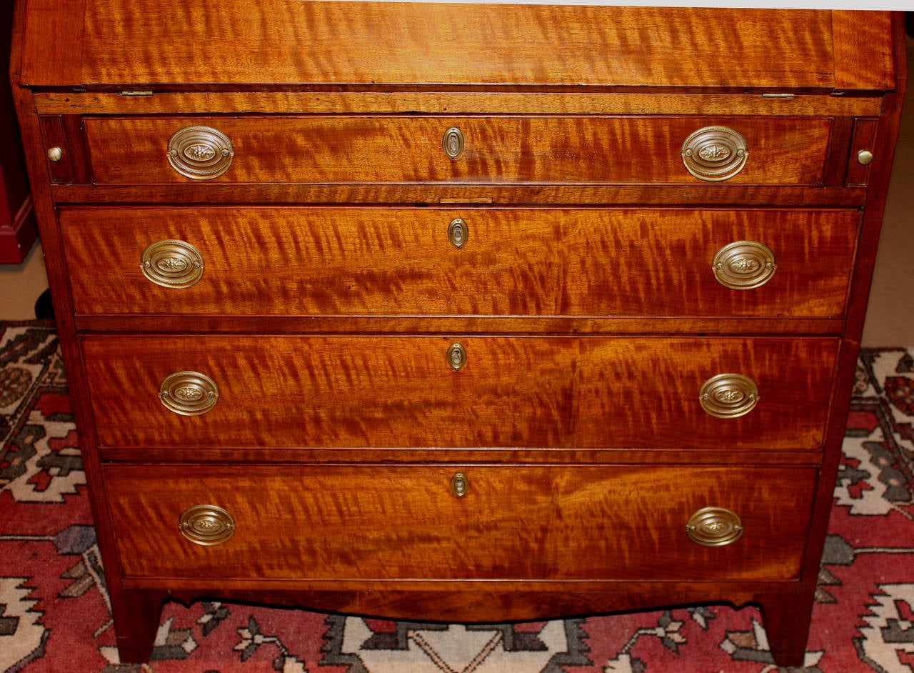 A Federal period walnut slant front desk with interior compartment featuring seven drawers, six cubbies and beautiful eagle oval inlay on the prospect door, which opens to reveal two additional drawers.