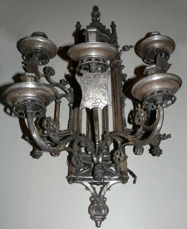 Gothic 5-arm sconce with figures of knights or soldiers under shields with engraved lions, crowns and banners.  Great detail.