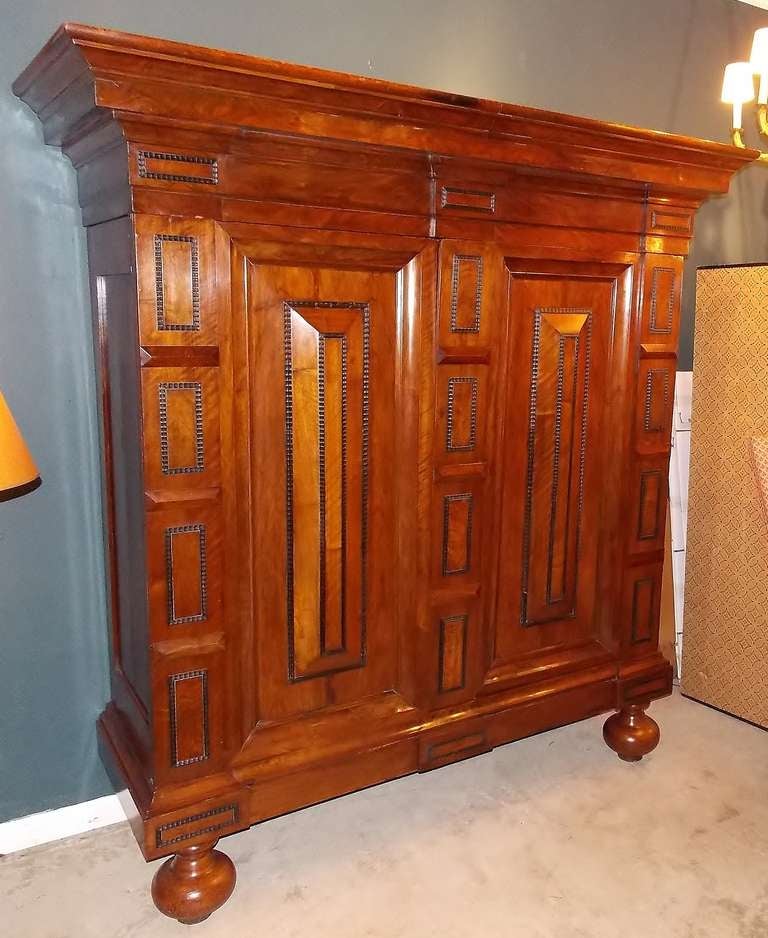 Dutch Baroque Kas or armoire with applied trim, nicely paneled and raised on bold turned feet. Beautifully conserved and polished.