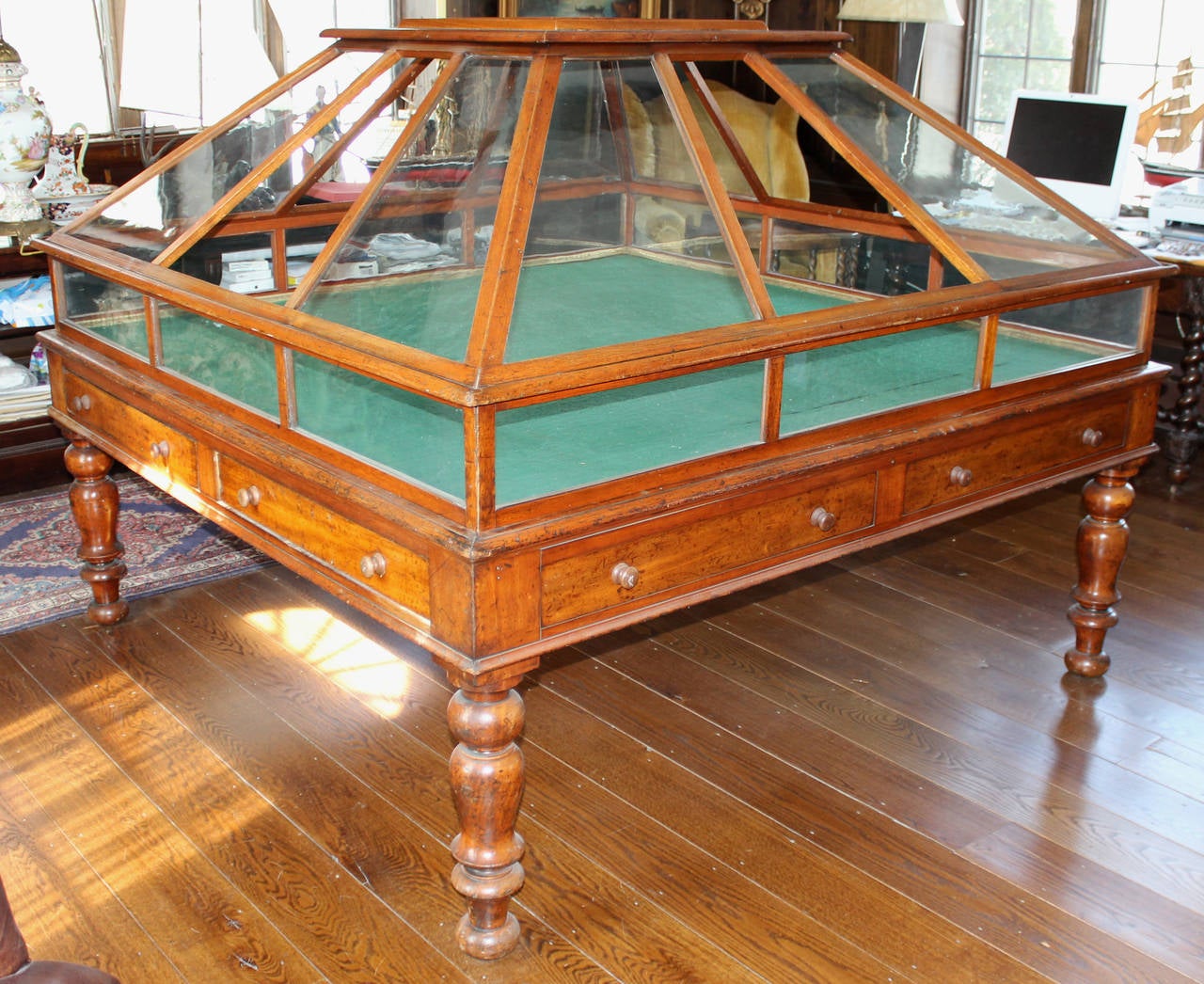 A spectacular mahogany and glass orchid display case, 19th century English, with an upper construction of 8 trapezoidal panels of glass over 9 smaller rectangle glass panels, formed together with mahogany slats, one section open on each of the four
