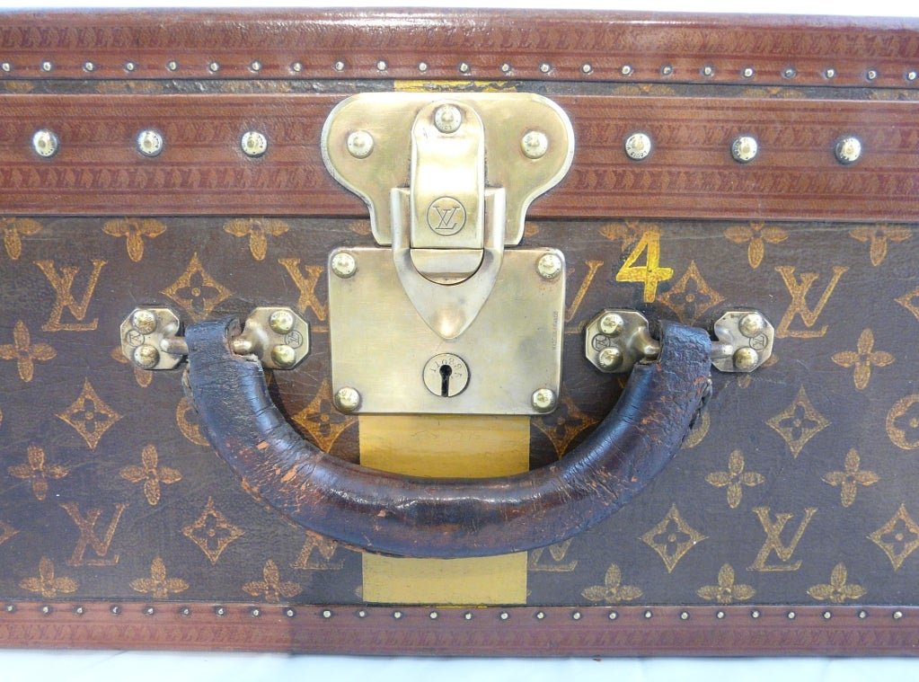Louis Vuitton vintage hardside luggage suitcase. Louis Vuitton monogrammed and embossed materials, leather trim and polished brasses.  Circa 1930's.
