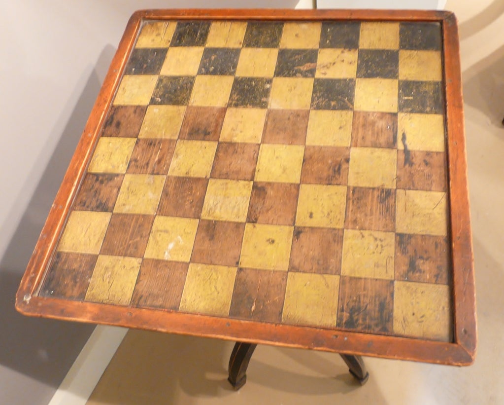 Checkerboard tray-top table above two drawers. The top supported by a block turned post with a tripod base of three legs terminating in spade feet. A fantastic Folk Art table with great polychrome decoration. From the mid-late 19th century.