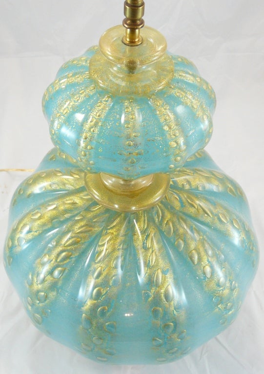 Italian Murano aqua glass lamp with great striations of gold flecking on a painted metal base.