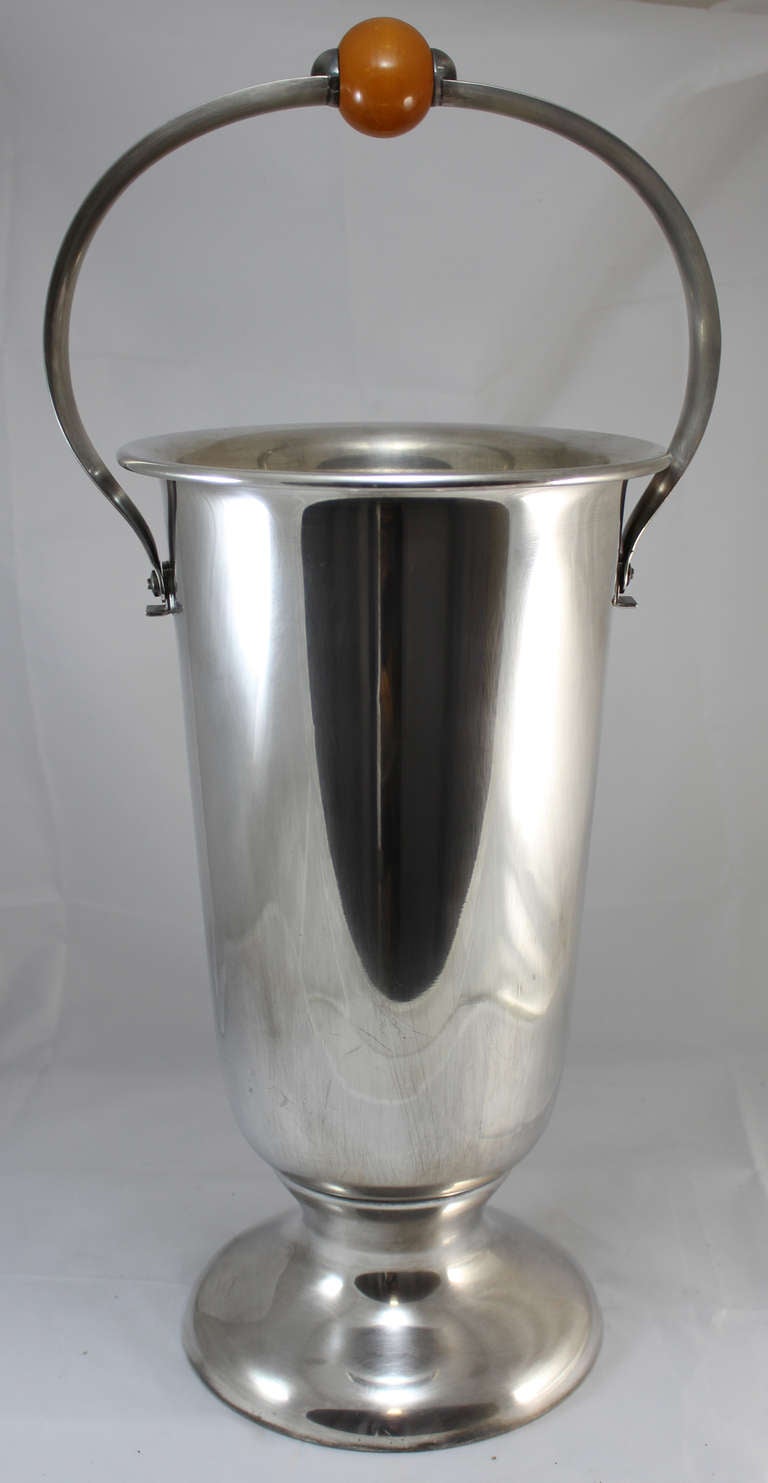 Art Deco champagne cooler with butterscotch bakelite center knob made by WMF (Württembergische Metallwarenfabrik) of Germany, with a WMF hallmark on the underside of the handle.