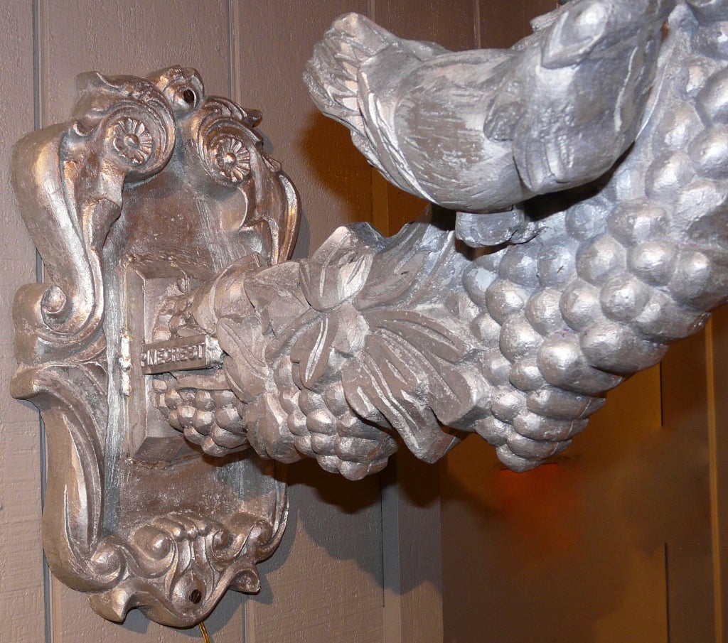 Large aluminum sconce with grape and bird motif. Bears the name 
