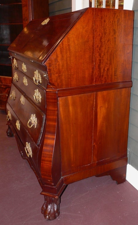 19th c. mahogany bombe desk with compartmentalized interior with sliding access panel to false top drawer compartment.  Serpentine drawers with nice ornate hardware.  Grand proportion and form.