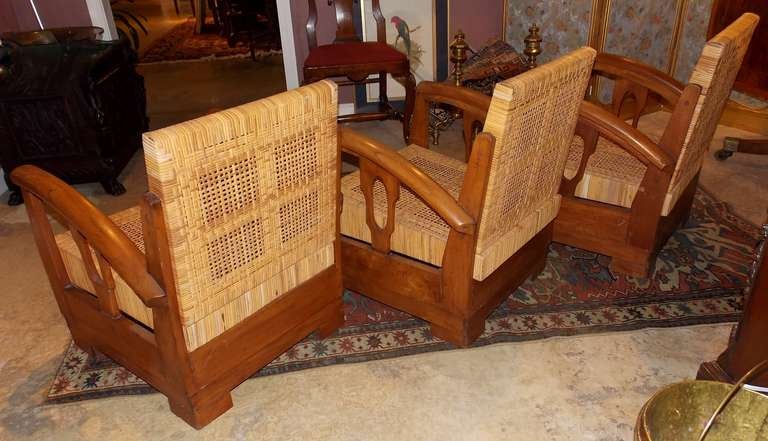 Three 1930s French lounge chairs, very much in the style of Francis Jourdain. The chairs are made of teak with a seat and backrest of intricately geometrically woven cane. The frame is in the Art Deco streamlined design and is circa 1930.