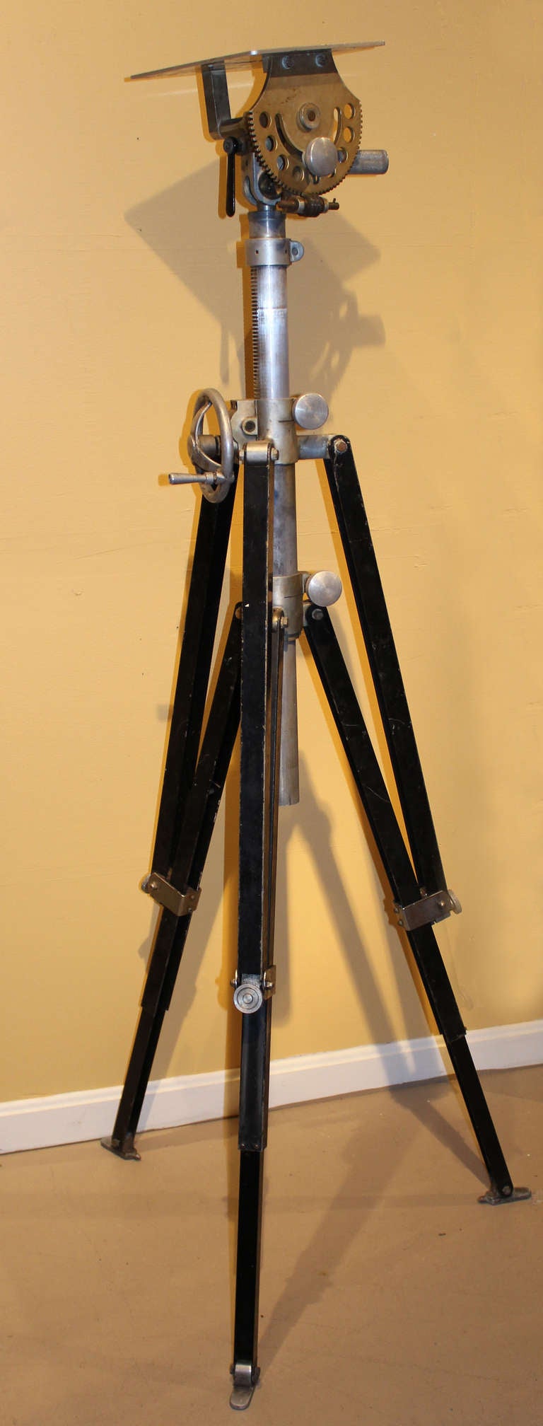 This heavy tripod of metal construction was used for Fastax high speed photography and movie cameras. The tripod has a plaque on the leg reading “Fastax Tripod” and the top of the tripod is marked C-284. These cameras were used in the 1950”™s and
