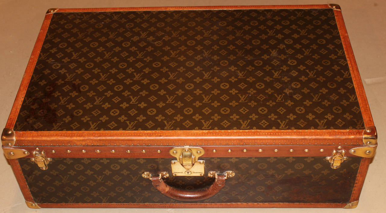 A Louis Vuitton hardside luggage suitcase with interior tray and key, circa 1950’s, S/N 802496 with interior gold paper label, refurbished to very good condition.