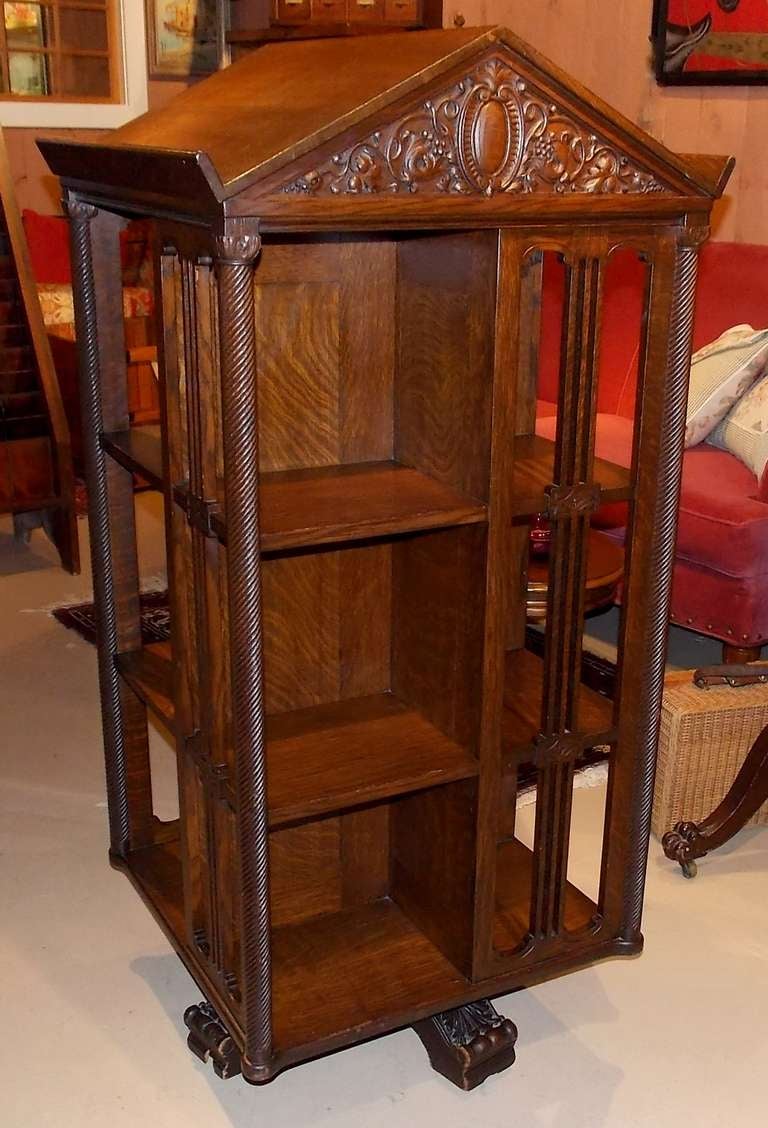 Very rare form 19th century revolving bookcase featuring steepled top with 2 book stands.  Quarter-sawn oak with  completely finished interior.  Rope-twist columned corners and carved adornments on substantial panel slats.