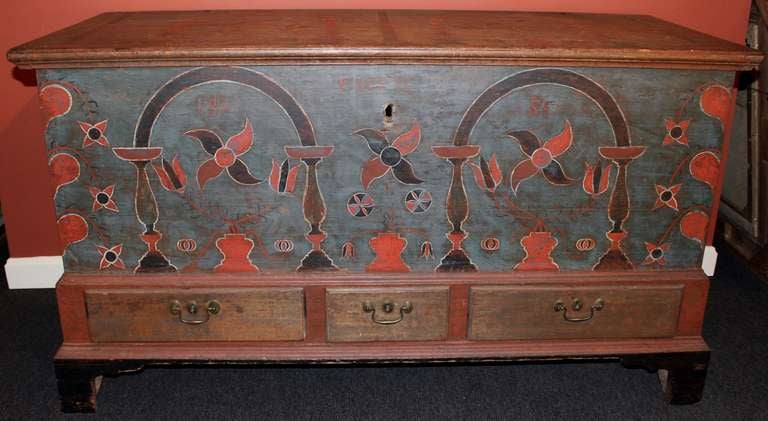 Berks County, PA painted dower chest, circa 1801. Retaining a vibrant decorated surface with tulips and pinwheel flowers on a blue ground. Provenance: Elliot and Ruth Herman Collection.