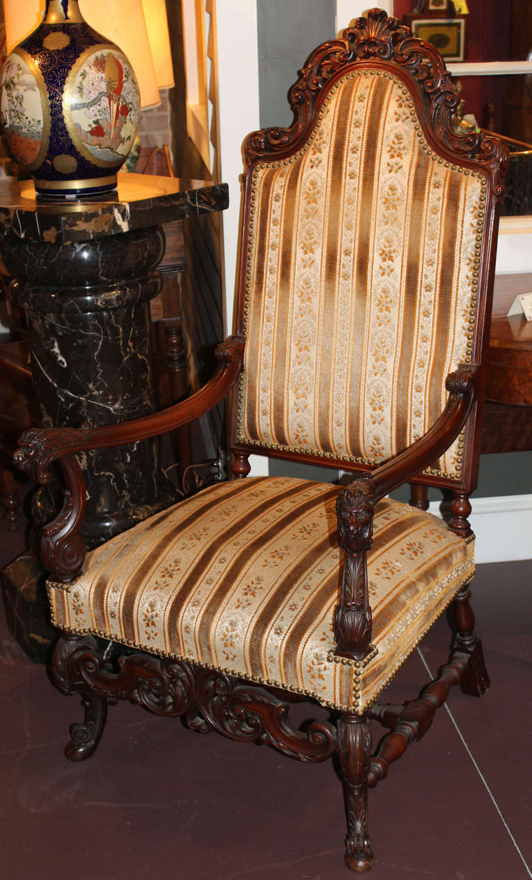 Renaissance Revival mahogany great chair with carved lion hand grips, and pierced foliate and scrollwork carving overall, late 19th century.
