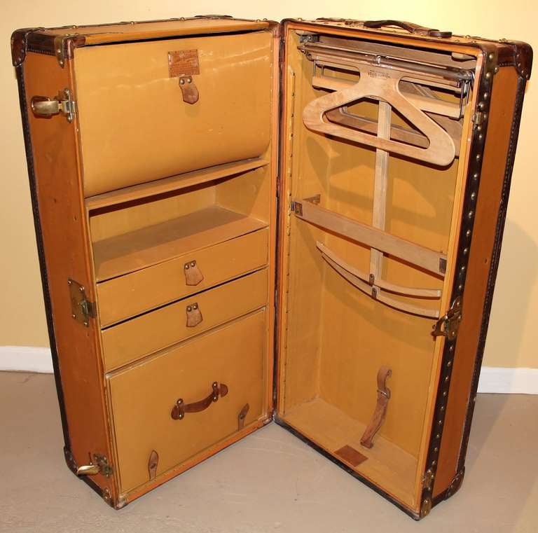 Rare Louis Vuitton wardrobe steamer trunk.  Exterior features orange Vuittonite trimmed with leather and brass hardware.