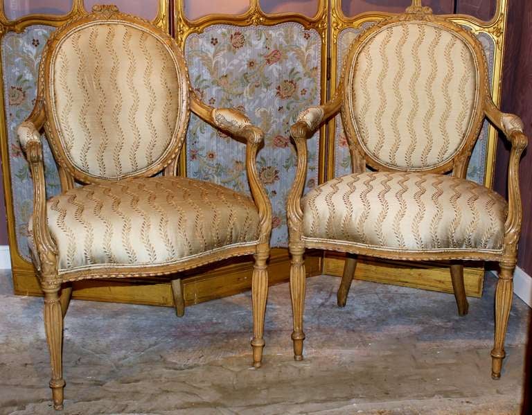 A very fine pair of George III arm chairs in the French taste. In beech, circa 1790-1810. Similar to a style by Thomas Chippendale.  Newly upholstered in silk.