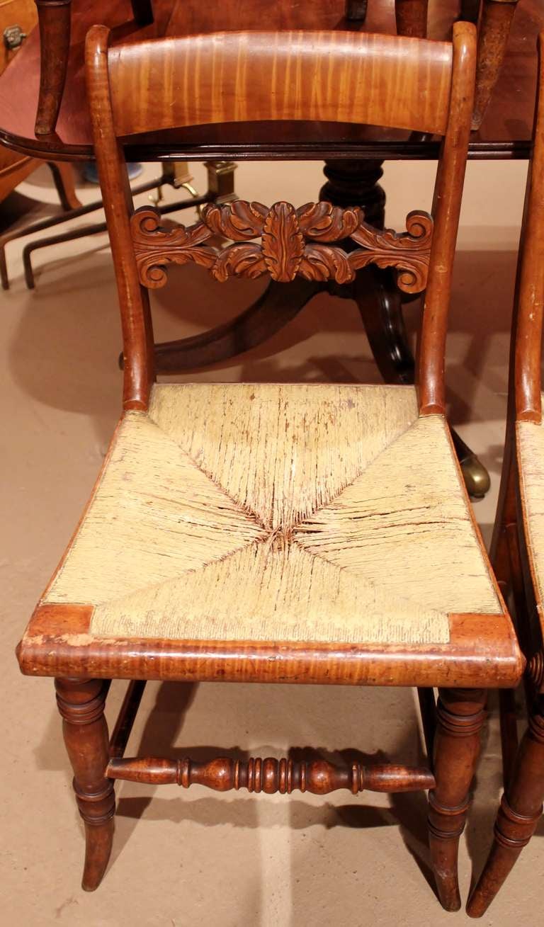 Fine set of 8 New England tiger maple chairs with woven seats that have been polychromed. Beautifully carved splat. Rare to find a set of eight.
