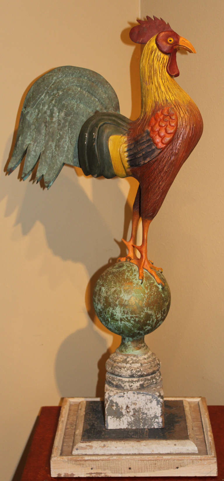 A colorful wooden folk art sculpture of a rooster with tin tail feathers created by self taught contemporary Roslyn Harbor, Long Island NY sculptor Thomas Langan (1942-). Tom began carving full time at age 35 when his subjects grew to include