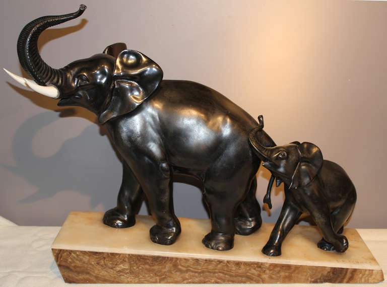 Elephant Art Deco sculpture by French artist Irenee Rochard (1906-1984). Irenee was born in Villefranche-sur-Saône, France and was a member of the French Artists Society as an animalist sculptor.  This patinated spelter sculpture is mounted to an